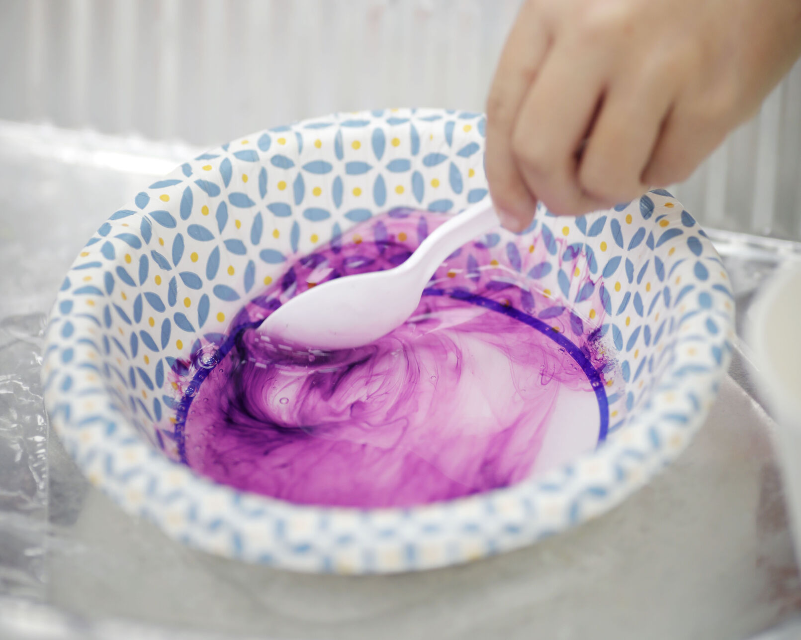 mixing purple dye in bowl